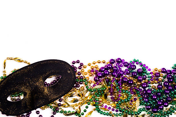 istock Mardi Gras background.  Purple, gold, green, mask, beads. 503980492