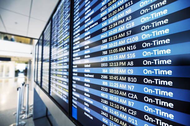 Flights information on modern departures board in airport terminal.