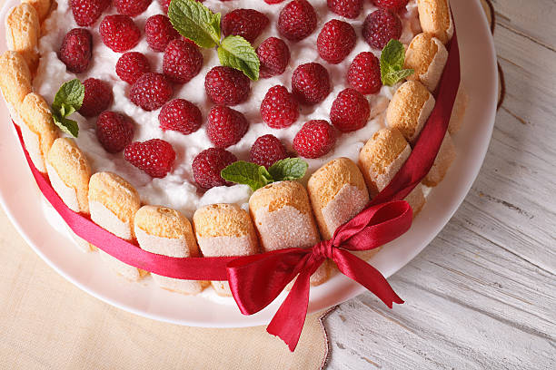 istock Delicate dessert raspberry cake with Savoiardi close up. horizon 503990264