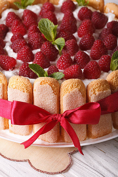 istock Beautiful raspberry charlotte cake on a plate close-up. Vertical 503990904