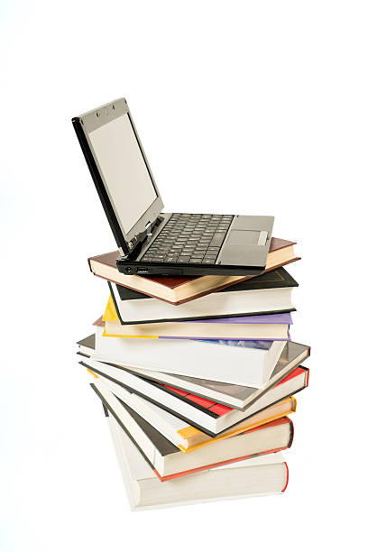 istock Stack of book and laptop isolated on white 503991130