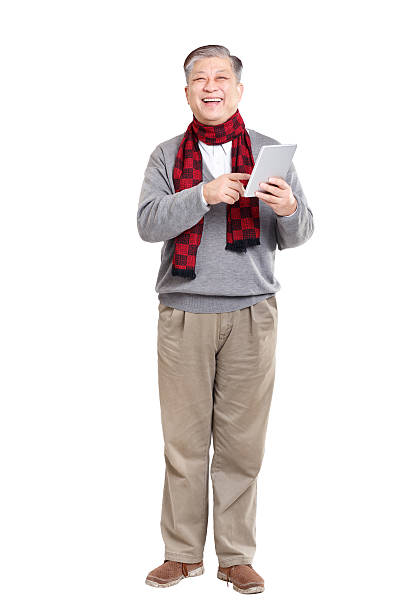 istock old standing Asian man in jumper with tablet 503991490