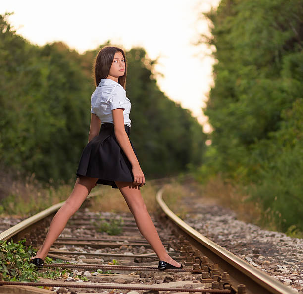 istock Young girl on the railway line 504003618