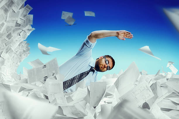 istock Man swimming in papers 504005388