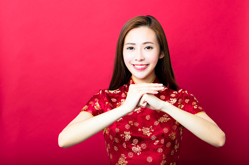 happy chinese new year.young woman with congratulation gesture