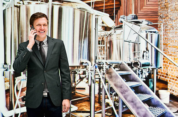 istock Smiling businessman on mobile at a brewery 504008632