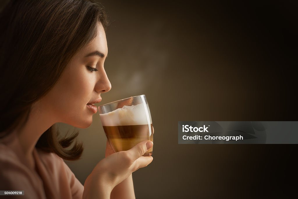 aromatic coffee Woman with an aromatic coffee in hands Coffee - Drink Stock Photo