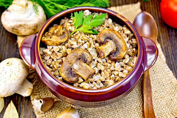 istock Buckwheat with champignons in clay bowl on table 504010344