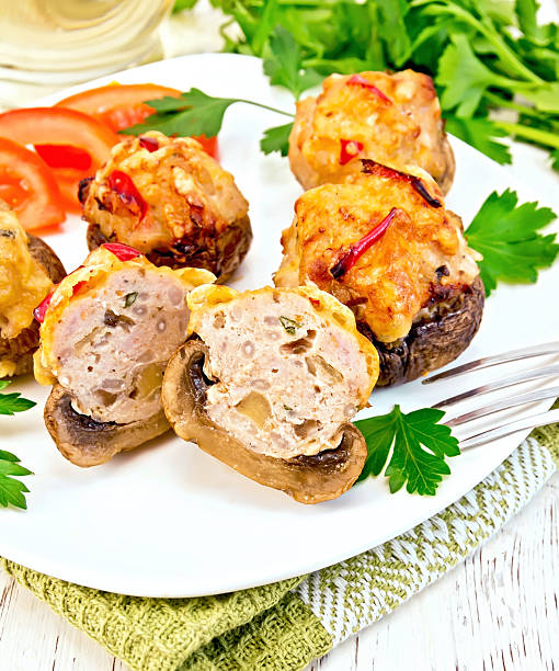 istock Champignons stuffed meat cut in white plate on napkin 504010420