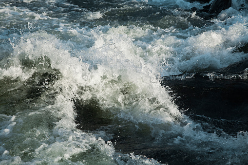 Turbulent water of a river as background