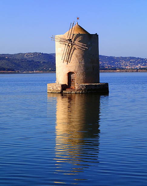 istock Old slanted windmill in water 504012402