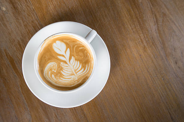 istock Cup of coffee on a wooden table top view. 504014316