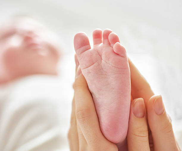 istock doctor examining a baby 504018270