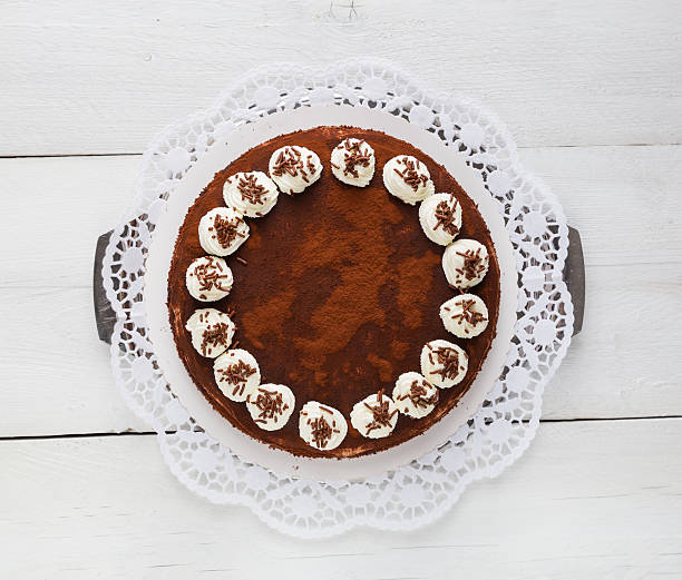 istock Tiramisu cake on white rustic wood 504029477