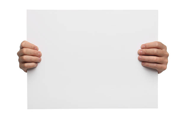 istock Male hands holding blank paper isolated on white background 504032627