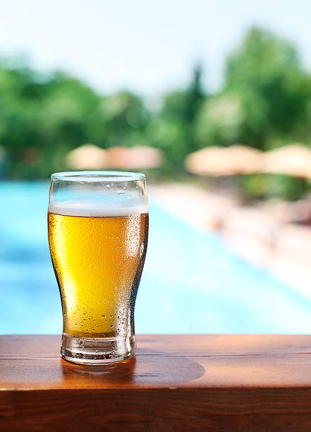 istock Cold beer glass on the bar table at open-air cafe. 504033231