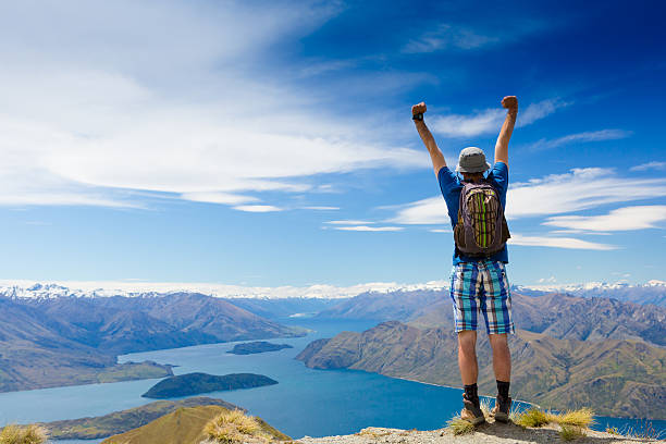 istock hiker lifts his arms in victory 504034025