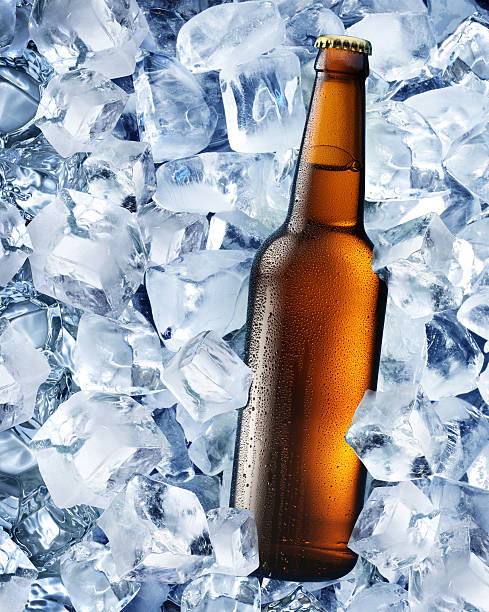 istock Bottle of beer in ice cubes. 504034333