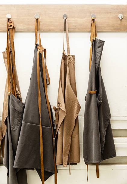 apron hanging on white wall stock photo