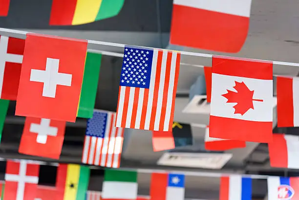 Photo of American, Canadian and Switzerland flags on a rope