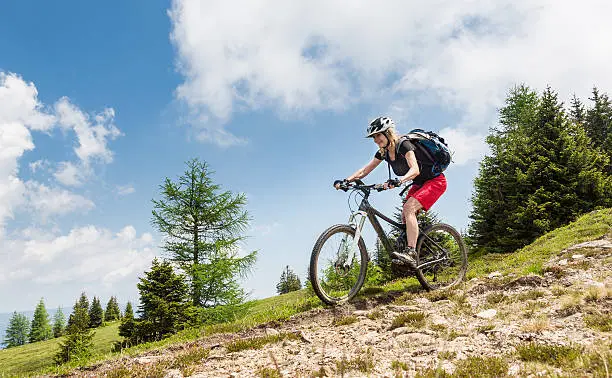 A female Mountainbiker on her fast downhill ride in the Carinthian mountains.