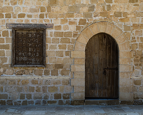 Alexandria, Egypt - December 3, 2015: Door and window of one of the rooms surrounding the main courtyard of Qaitbay Castle, a fort of Alexandria, Egypt, A 15th-century defensive fortress located on the Mediterranean sea coast, established in 1477 AD (882 AH)