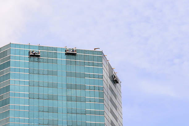 istock Group of Workers Cleaning Windows Service on Highrise Building. 504040116