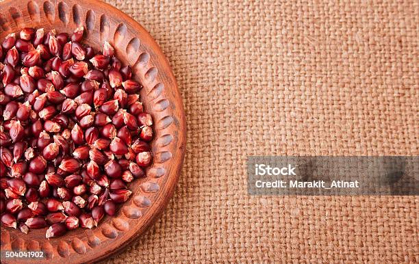 Hulled Corn Seeds On Burlap Background Stock Photo - Download Image Now - Brown, Burlap, Cereal Plant