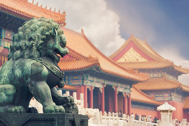 Forbidden city, Beijing Old imperial lion sculpture in front of historical Forbidden City buildings. beijing stock pictures, royalty-free photos & images