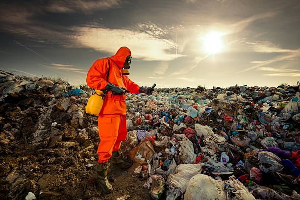 Waste Management Environmental engineer measuring air pollution on the municipal landfill. rubbish heap stock pictures, royalty-free photos & images