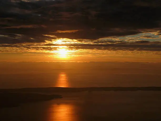 Golden sunset over the Adriatic Sea and Islands, with dramatic clouds. The wiew from the mountain.
