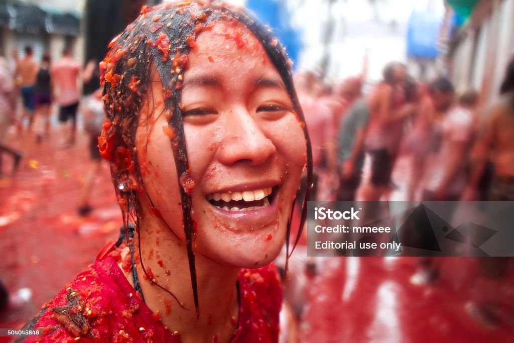 Tomatina festival Bunol, Spain - August 28, 2013: The girl in crushed tomatoes laughs on Tomatina festival in Bunol La Tomatina Valencia Stock Photo