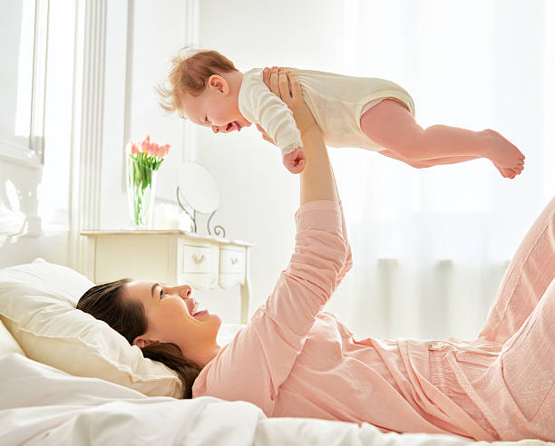 istock mother playing with her baby 504046036