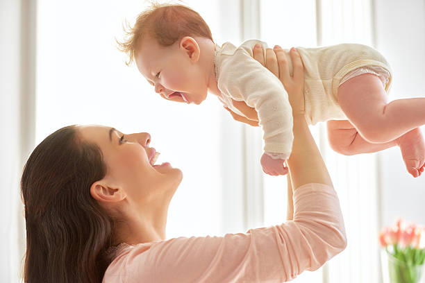 istock mother playing with her baby 504046098