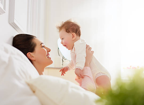 istock mother playing with her baby 504046176