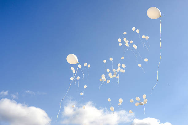 istock White balloons flying in the sky 504048666