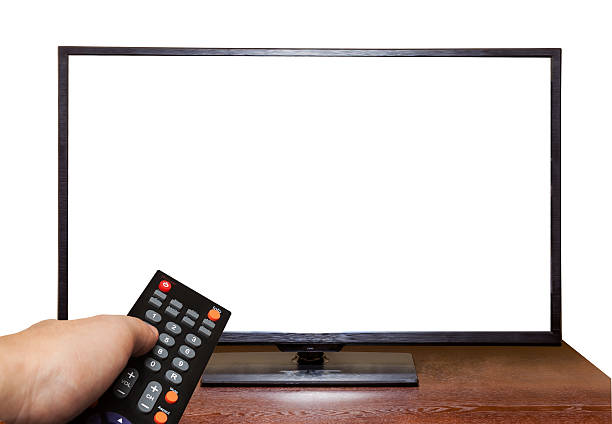 istock Blank screen TV on table and hand holding Remote Control 504052807