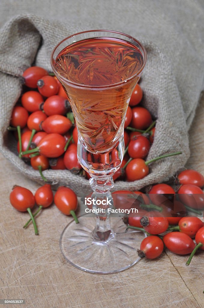 Rosehip fruit and alcoholic liquor Rosehip fruit and alcoholic liquor in a glass Rose Hip Stock Photo