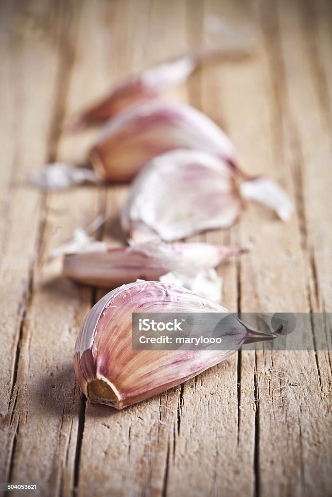 cloves of garlic cloves of garlic closeup on wooden table Close-up Stock Photo