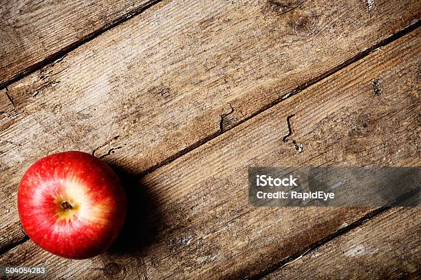 An Apple A Day Single Fruit On Weathered Wood Stock Photo - Download Image Now - Apple - Fruit, Autumn, Color Image