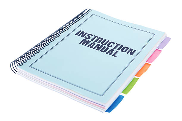 Instruction Manual - Bound Paperwork Document on White Instruction Manual - Large bound business documents in book form with dividers with a blue cover - isolated on a white background.  Paperwork on white. instruction manual photos stock pictures, royalty-free photos & images