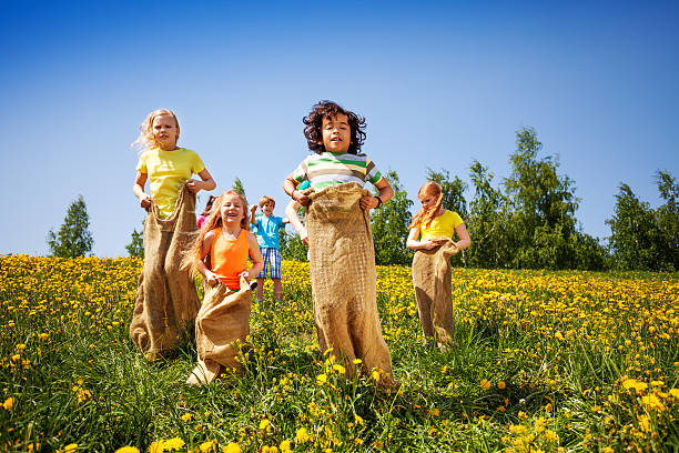 istock Children jumping in sacks playing together 504055699