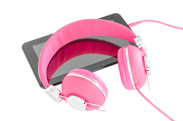 istock Vibrant pink female headphones and black tablet pc 504056143