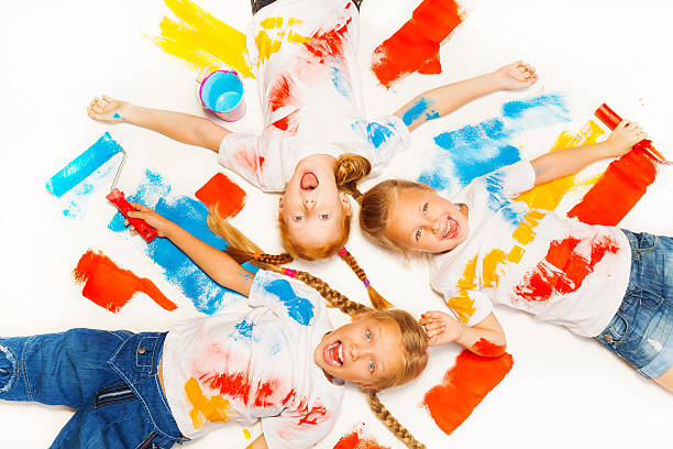istock Three little kids lay on the floor and laugh 504056251