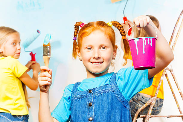 istock Young smiling girl performs painting accessories 504056285