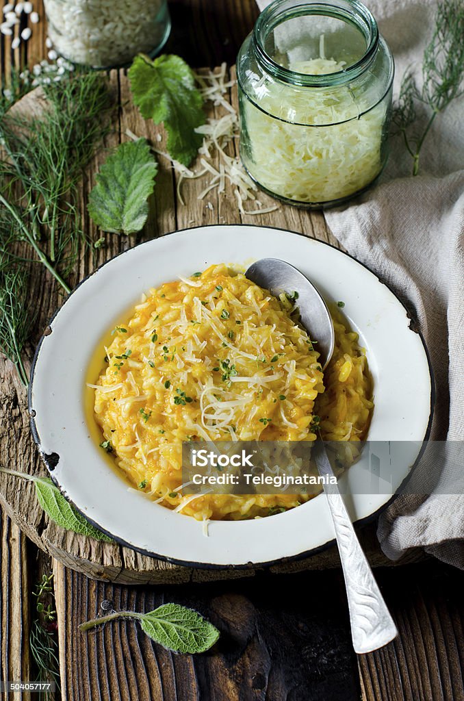 Carrot risotto in the plate on wooden table Arborio Rice Stock Photo