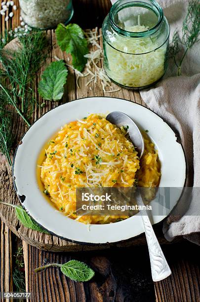 Carrot Risotto In The Plate On Wooden Table Stock Photo - Download Image Now - Arborio Rice, Backgrounds, Barley
