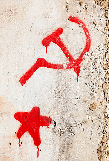 istock Hammer and sickle next to a red star on wall. 504067408