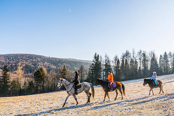 Three girls go horseback riding. Wierchomla Mala, Poland - January 02, 2016: Girls riding horses in the mountains. beskid mountains photos stock pictures, royalty-free photos & images