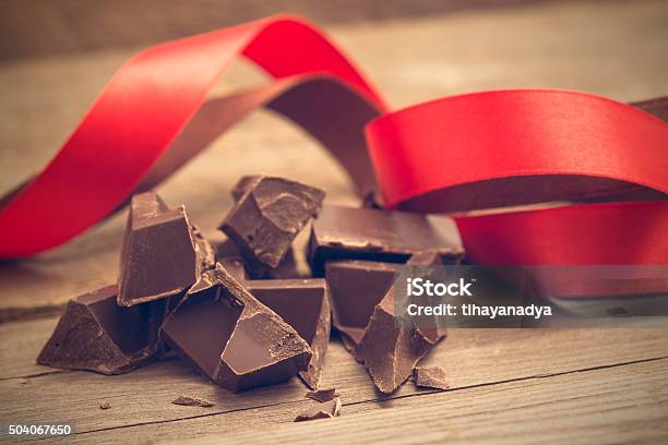 Pieces Of Chocolate Bar With Red And Brown Ribbon Stock Photo - Download Image Now - Backgrounds, Brown, Chocolate